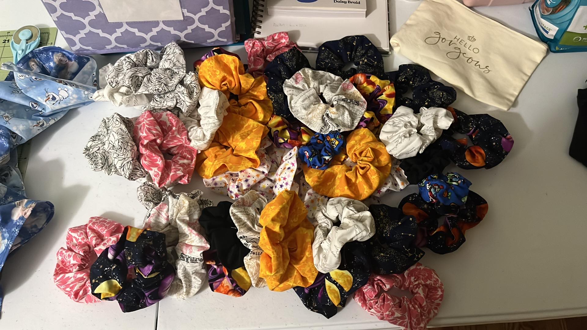 a table with 40 scrunchies in various patterns in a pile